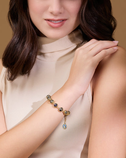 Gold-tone Rosary Bracelet with Blue Crystal Beads and Bead Caps
